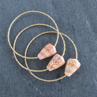 Orange spot cone shell bangle bracelet by Yay Hawaii, featuring vibrant orange shell with natural cone shape and decorative design.