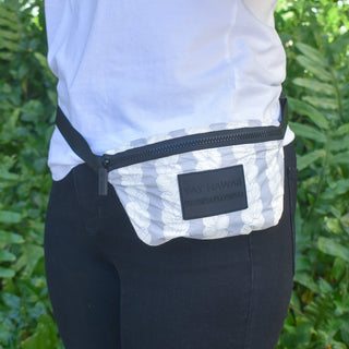 Yay Hawaii Double Pikake Lei Tyvek Fanny Pack with floral design and adjustable strap, worn around the waist.