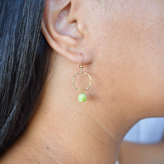 Small hoop earrings with dangling Pakalana flowers, stylish jewelry by Yay Hawaii featuring floral designs and gold-tone hoops.