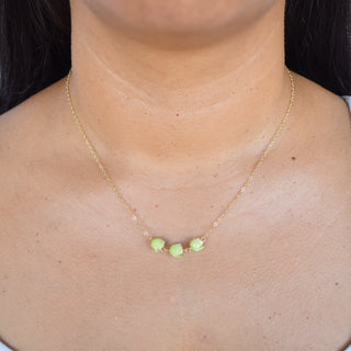 Three linked Pakalana station necklace by Yay Hawaii featuring a delicate floral design with green and purple hues.