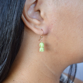 Double Cluster Pakalana earrings by Yay Hawaii featuring floral design with green and white petals on gold hooks.