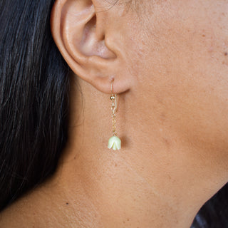 Yay Hawaii single dangle Pakalana flower earrings featuring yellow blossoms and gold hooks on a plain background