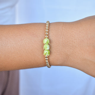 Metal beaded stretchy bracelet with three Pakalana flowers by Yay Hawaii, featuring colorful beads and floral accents.