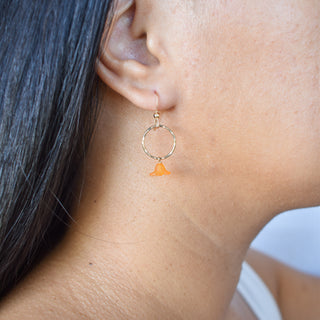 Small hoop earrings with dangling Puakenikeni flowers from Yay Hawaii, featuring delicate floral design and silver hoops.