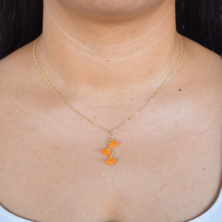 Three cascading Puakenikeni flower necklaces from Yay Hawaii, featuring vibrant tropical flower designs on string cords.