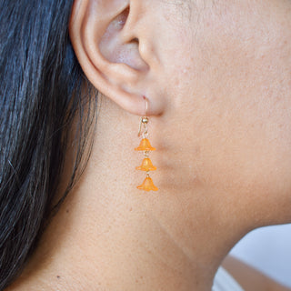 Dangling three-link Puakenikeni earrings by Yay Hawaii featuring floral-inspired jewelry with gold-tone links and intricate design.