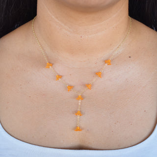 Dangling Puakenikeni Y-shape lariat necklace by Yay Hawaii with floral pendant and adjustable chain on a white background.