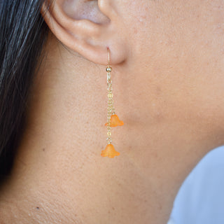 Double dangle Puakenikeni earrings by Yay Hawaii featuring floral design and gold-tone hooks, hanging gracefully against a neutral background.