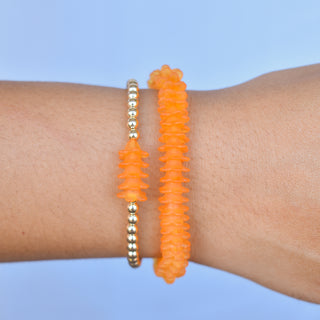 Metal beaded stretchy bracelet with Puakenikeni flower accents from Yay Hawaii showing colorful beads and floral details.