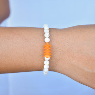 Mother of pearl round beaded stretchy bracelet with Puakenikeni flowers by Yay Hawaii, showing colorful beads and floral accents.