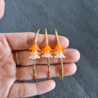 Yay Hawaii Shaded Trio Puakenikeni Bangle with layered floral design and warm amber tones on a white background.