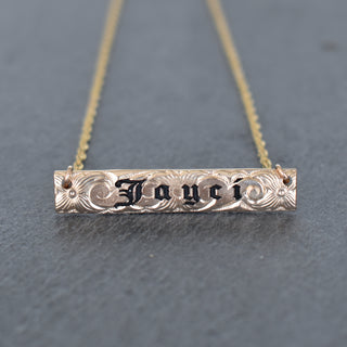 Yay Hawaii Inoa patterned bar necklace with geometric design in gold on a chain, stylish jewelry accessory.