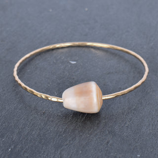 Tan cone shell bangle by Yay Hawaii featuring a smooth, rounded shell design perfect for beach-inspired jewelry.