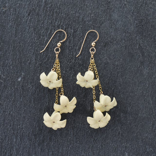Yay Hawaii Triple Dangle Big Puakenikeni earrings in vibrant colors featuring layered flower designs on gold hooks.