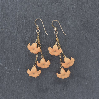 Yay Hawaii Triple Dangle Big Puakenikeni earrings in vibrant colors, featuring layered flower designs on gold-tone hooks.