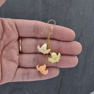 Yay Hawaii triple dangle Puakenikeni earrings in vibrant color, featuring layered floral designs on gold-tone hooks.