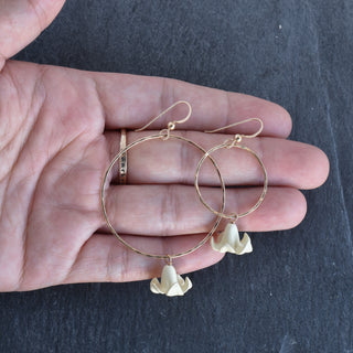 Large hoop earrings by Yay Hawaii with dangling Big Puakenikeni flowers in various colors, showcasing vibrant floral jewelry.