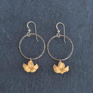 Yay Hawaii medium hoop earrings with dangling large Puakenikeni flower in various colors, showcasing tropical floral jewelry design.