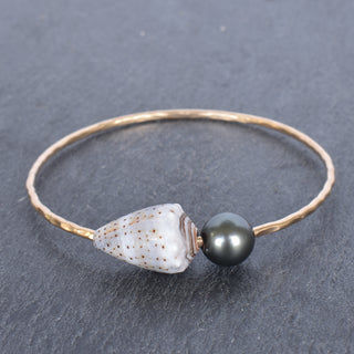 Abbreviated cone shell bangle with Tahitian pearl from Yay Hawaii, featuring a sleek shell design and a lustrous black pearl detail.