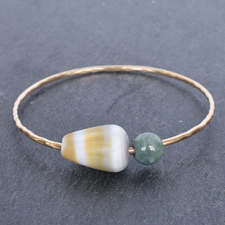 Yellow cone shell bangle with Burmese jade accents, handcrafted jewelry by Yay Hawaii featuring ocean-inspired design.