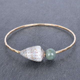 Abbreviated cone shell bangle with Burmese jade accents, crafted by Yay Hawaii, showcasing a stylish jewelry accessory.
