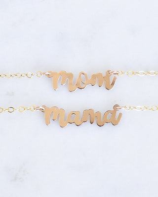 Mini Mom and Mama necklaces by Yay Hawaii featuring delicate gold chains and pendant charms on a neutral background.