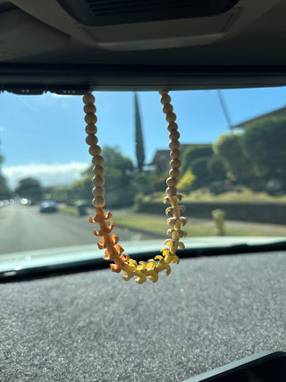 Fresh Puakenikeni flower lei from Yay Hawaii, showcasing vibrant yellow blossoms on a traditional Hawaiian car lei.