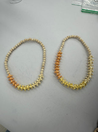 Yellow Puakenikeni flower lei for cars from Yay Hawaii, featuring fresh tropical blossoms on a string for decorative use.
