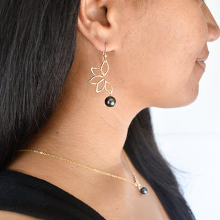 Large Naupaka earrings by Yay Hawaii featuring intricate floral designs and silver hooks on a plain background.