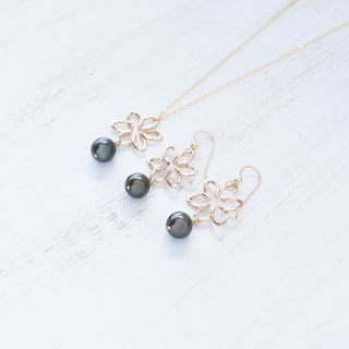 Small Na'u flower earrings by Yay Hawaii featuring 8mm black freshwater pearls, delicate floral design, and silver hooks.