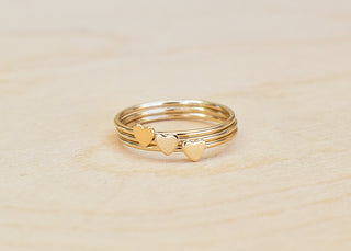 Silver Tiny Heart Stacking Ring by Yay Hawaii, close-up of delicate band with small heart detail on a white background.