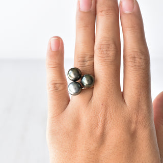 Tahitian pearl Kahi stacking ring by Yay Hawaii featuring a black pearl set on a gold band with intricate design details.