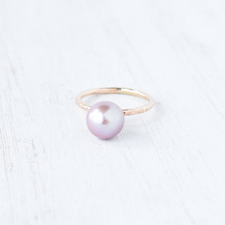 Purple Edison Kahi stacking ring by Yay Hawaii, featuring a vibrant purple gemstone and gold band, styled as a modern jewelry piece.