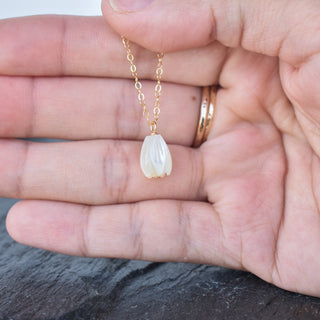 Medium Pikake dangling necklace by Yay Hawaii featuring a floral pendant and silver chain on a white background.
