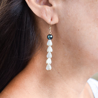 Long statement earrings featuring five mother of pearl Pikake flowers and black freshwater pearls by Yay Hawaii