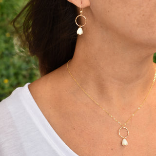 Silver hoop earrings with dangling small mother of pearl Pikake flower charms, by Yay Hawaii.