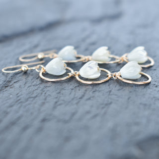 Yay Hawaii statement triple hoop earrings with small mother of pearl Pikake flower beads on silver hoops.