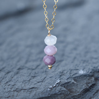 Purple ombre cluster necklace by Yay Hawaii featuring layered beads and vibrant purple hues, styled on a neutral display.