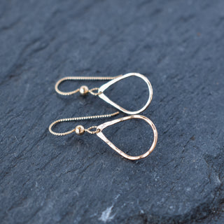 Tiny teardrop hoop earrings by Yay Hawaii featuring delicate gold hoops with a teardrop shape.