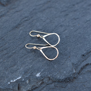 Tiny teardrop hoop earrings by Yay Hawaii featuring delicate gold hoops with a subtle teardrop shape.