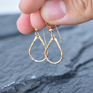 Tiny teardrop hoop earrings by Yay Hawaii, gold-plated jewelry with delicate teardrop-shaped hoops on a white background.