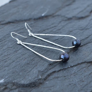 Long teardrop earrings with pearls by Yay Hawaii, featuring elegant pearl-accented teardrop-shaped dangles.