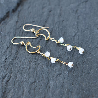 Dangling crescent moon earrings with white jade crystal glass beads, featuring Yay Hawaii jewelry design.