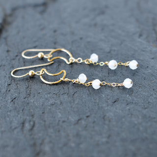 Dangling crescent moon earrings by Yay Hawaii featuring white jade crystal glass beads and silver hooks.