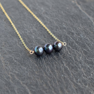 Yay Hawaii black freshwater pearl bar necklace with 8mm pearls, elegant jewelry piece on a delicate chain.