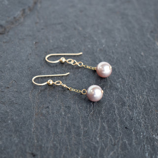 Dainty light purple pearl single dangle earrings by Yay Hawaii featuring elegant pearl and silver hook design.