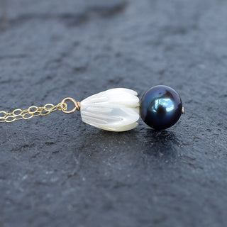 Medium Mother of Pearl Pikake flower necklace with black freshwater pearl cluster, featuring elegant Hawaiian jewelry design.