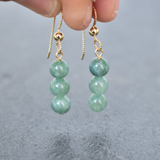 Triple 6mm jade cluster earrings by Yay Hawaii featuring vibrant green jade stones and gold-tone hooks.