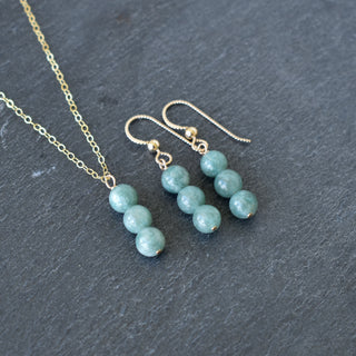 Triple 6mm jade cluster earrings by Yay Hawaii with vibrant green jade stones and silver hooks, displayed on a neutral background.