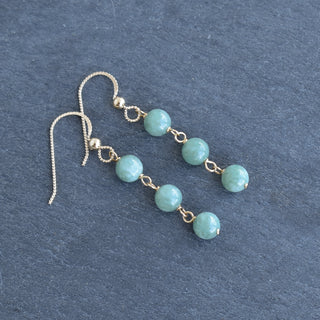 Triple linked 6mm jade dangle earrings featuring polished green jade beads and silver hooks, designed by Yay Hawaii.